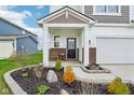 Charming front porch with landscaped garden, small patio, and manicured lawn at 8663 Kellner St, Pendleton, IN 46064