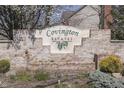 Stone sign for Covington Estates, complemented by manicured bushes and spring foliage at 9760 Logan Ln, Fishers, IN 46037