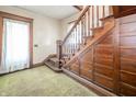 Elegant staircase featuring detailed wood trim and a decorative paneled wall at 10723 E State Road 234, Wilkinson, IN 46186