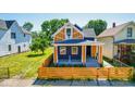 Beautiful exterior of a two-story home featuring manicured landscaping, a new fence, and fresh paint at 1321 Union St, Indianapolis, IN 46225