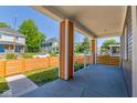 Inviting front porch featuring sturdy columns, a concrete floor, and a new orange horizontal wooden fence at 1321 Union St, Indianapolis, IN 46225
