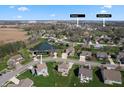 An aerial view of the home in a suburban neighborhood surrounded by greenery and a pond at 145 Stamford Dr, Pittsboro, IN 46167