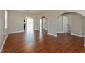The open-concept living room features beautiful hardwood floors and elegant arched doorways at 145 Stamford Dr, Pittsboro, IN 46167