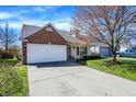Well-kept single Gathering home with attached garage, brick facade, and green lawn at 14917 Mia Dr, Carmel, IN 46033
