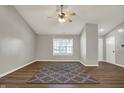 Open living room with neutral paint, ceiling fan and luxury vinyl plank flooring at 14917 Mia Dr, Carmel, IN 46033