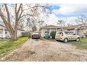Exterior view of a single-Gathering home with gravel driveway and small yard at 1504 S Lynhurst Dr, Indianapolis, IN 46241