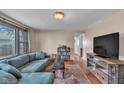 Comfortable living room with hardwood floors, large sofa, and natural light at 1504 S Lynhurst Dr, Indianapolis, IN 46241