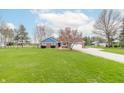 A charming single-story brick home with a well-maintained lawn and a long driveway at 1737 W 200 N, Greenfield, IN 46140