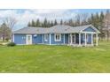 The home's exterior with a backyard, patio, and blue siding is ideal for outdoor activities at 1737 W 200 N, Greenfield, IN 46140