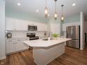 Modern kitchen featuring white cabinets, stainless steel appliances, and a large center island at 182 Batteese Dr, Cicero, IN 46034