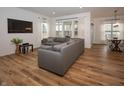Sun-filled living room boasts hardwood floors, recessed lighting, and comfortable sectional seating at 182 Batteese Dr, Cicero, IN 46034