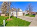 A long driveway leads to a spacious garage and a basketball hoop for outdoor fun at 1950 Midnight Pass, Brownsburg, IN 46112