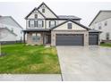 Charming two-story home features a 3-car garage and a welcoming brick facade at 20398 N Pacific Ave, Westfield, IN 46074