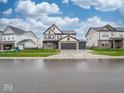 Charming two-story home features a 3-car garage and a welcoming brick facade at 20398 N Pacific Ave, Westfield, IN 46074