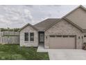 Inviting front exterior showcasing the brick facade, well-maintained lawn, and attached garage at 2144 Connie Ct, Franklin, IN 46131