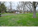 View of the home's exterior including the long driveway and two car garage at 2302 W 61St St, Indianapolis, IN 46228