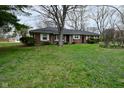 A ranch style home with a front lawn covered in purple wildflowers at 2302 W 61St St, Indianapolis, IN 46228