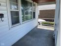 Covered porch with white railings offers a shaded outdoor space at 249 N 15Th Ave, Beech Grove, IN 46107
