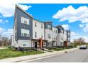 Modern townhome with landscaped front yard and blue and gray exterior paint, showcasing a contemporary design at 3123 Bolton Square Blvd, Indianapolis, IN 46222