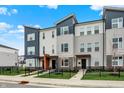Modern townhome exterior with blue and grey siding and well-maintained landscaping with a black fence at 3123 Bolton Square Blvd, Indianapolis, IN 46222