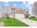 Spacious two-story home with a two-car garage, manicured lawn, and mature trees at 3130 Shadow Lake Dr, Indianapolis, IN 46217