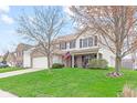Attractive two-story house featuring brick and siding, an attached garage, and a green lawn at 3130 Shadow Lake Dr, Indianapolis, IN 46217