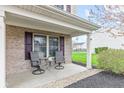 Cozy covered front porch featuring outdoor seating and brick detailing at 3130 Shadow Lake Dr, Indianapolis, IN 46217