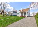 Traditional-style home showcasing a driveway and a well-kept lawn at 334 N 15Th Ave, Beech Grove, IN 46107