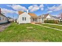 Quaint home featuring a well-maintained lawn and classic architectural details at 334 N 15Th Ave, Beech Grove, IN 46107