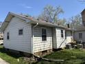 Rear view of the property showcasing siding and windows, with outdoor equipment nearby at 3751 Creston Dr, Indianapolis, IN 46222