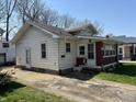 Home exterior showing white siding and a small porch area with entrance on the side at 3751 Creston Dr, Indianapolis, IN 46222