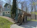 Charming two story home with elevated deck and staircase surrounded by lush green landscaping at 3764 E Glenwood Dr, Martinsville, IN 46151