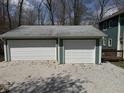 Spacious two-car garage with white doors and light green trim, offering ample parking and storage at 3764 E Glenwood Dr, Martinsville, IN 46151