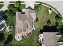 Aerial view of a home showing its backyard patio with a fire pit and seating area, and the surrounding landscape at 3789 Shady Pointe Row, Greenwood, IN 46143