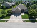 An aerial view showing the home's landscaped lawn, three-car garage, and the peaceful neighborhood surroundings at 3789 Shady Pointe Row, Greenwood, IN 46143