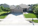 A single-story brick home featuring a three-car garage and a well-maintained lawn, viewed from an aerial perspective at 3789 Shady Pointe Row, Greenwood, IN 46143