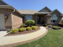Attractive brick home featuring a stone walkway and well-maintained landscaping with flowering bushes at 415 N Westview Dr, Columbus, IN 47201