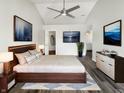 Serene primary bedroom featuring sleek flooring, a modern ceiling fan, and elegant décor at 4630 Kelvington Dr, Indianapolis, IN 46254