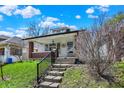 View of the house with a welcoming front porch and beautiful landscaping at 52 N Oakland Ave, Indianapolis, IN 46201