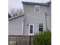 Exterior shot showing back of home with gray siding and access to deck at 601 E Thompson St, Edinburgh, IN 46124