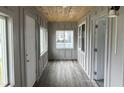 Bright entryway with paneled walls, hardwood flooring, and a view of the outdoors through multiple windows at 608 N Gray St, Indianapolis, IN 46201