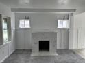 A cozy fireplace anchors the living room with classic trim, offering the perfect spot to gather at 608 N Gray St, Indianapolis, IN 46201
