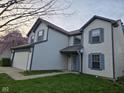 Angle view of a two-story home with a two-car garage, blue shutters, and a manicured lawn at 6120 Salanie Pl, Indianapolis, IN 46254