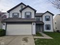 Charming two-story home with a two-car garage, blue shutters, and a well-maintained front yard at 6120 Salanie Pl, Indianapolis, IN 46254