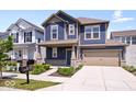 Attractive home with a covered front porch, a two-car garage, and curb appeal at 7012 Pickett Pl, Carmel, IN 46033