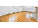 Bright living room with beautiful hardwood floors and a charming decorative fireplace at 709 S A St, Elwood, IN 46036