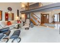 Spacious living room with high ceilings, a staircase, and comfortable seating at 7371 Windridge Way, Brownsburg, IN 46112