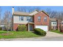 Traditional two-story home with a white garage door and well-manicured landscaping at 7418 Bluebird Ct, Indianapolis, IN 46254
