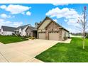 Lovely home with a well-maintained lawn, a two-car garage, and inviting curb appeal at 749 Meadowbrook Ln, Franklin, IN 46131