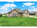 Charming home with lush lawn, stone accents, and a two-car garage on a sunny day at 749 Meadowbrook Ln, Franklin, IN 46131